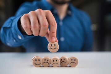 Wooden label with happy normal and sad face icons for experience survey services and products review concept. Customer or Client show Good Neutral or Negative feedback and satisfaction rating.