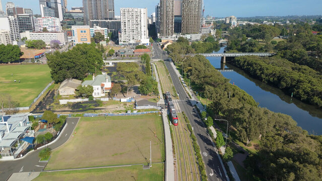 Aerial drone view of a light rail vehicle at Parramatta cbd in Western Sydney, NSW, Australia as it travels along George Street in November 2024 
