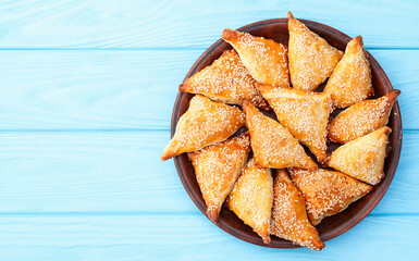 Homemade triangle puff pastry with meat on rustic background . Samosa