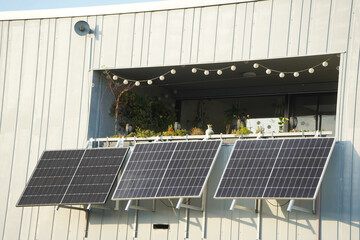 A large balcony power plant in front of a green balcony