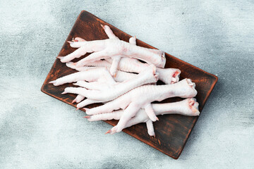 Raw chicken foot ( paws ) Top view on rustic background © whitestorm