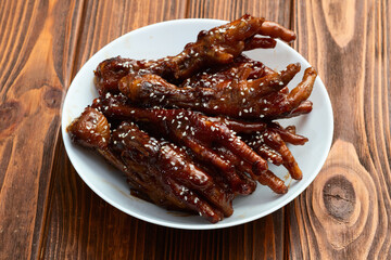 Caramelized korean or Chinese chicken foots ( paws ) with sesame . Top view