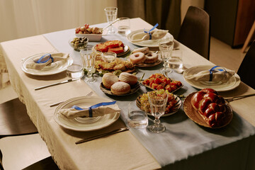 High angle shot of table with different kinds of pastries on polished ceramic plates