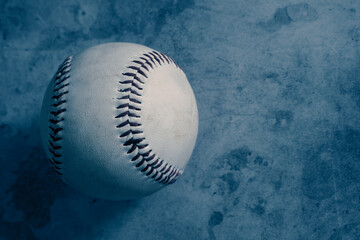 Baseball on blue texture background with copy space for sprot.