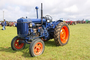 Obraz premium Vintage tractor standing in a field 