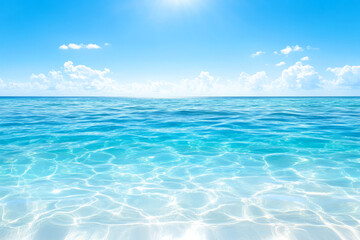 Obraz premium Luminous turquoise ocean water under bright blue sky with soft clouds