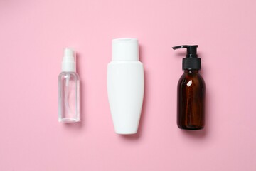 Cosmetic bottles on color background 
