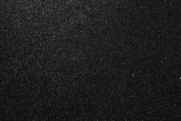 Black glitter texture sparkling shiny wrapping paper background for Christmas holidays seasonal wallpaper decoration, greeting and wedding invitation design element