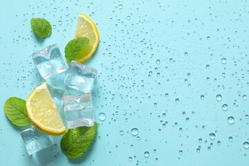 Top view photo of mint leaves and sliced of lemon, ice cubes and water drops on pastel blue background  © Sunlight
