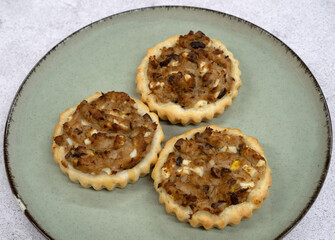 Gourmet mini tarts. Closeup view of fresh baked tuna fish pies