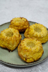 Closeup view of fish and pumpkin muffins in a dish on the white table