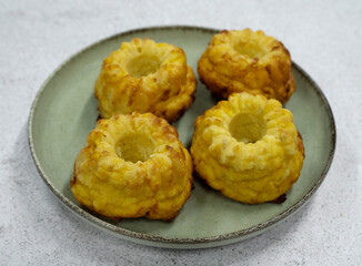 Closeup view of fish and pumpkin muffins in a dish on the white table	