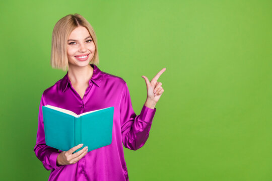 Photo of elegant lovely girl wear stylish magenta clothes hold book empty space isolated on green color background