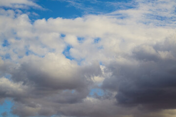 Close-up of white cumulus clouds in the sky, indicating good weather.