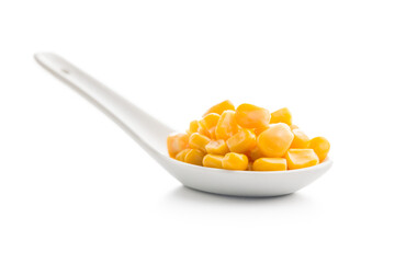 Canned sweet corn in ceramic spoon isolated on white background.