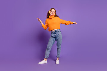 Full size photo of nice young girl headphones dancing wear pullover isolated on violet color background