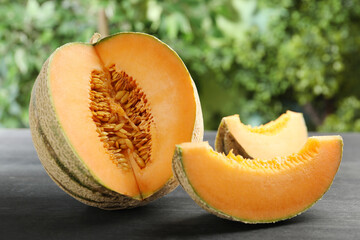 Fresh ripe Cantaloupe melon on dark wooden table, closeup