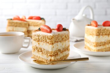 Piece of delicious carrot cake on white wooden table, closeup