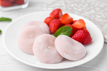 Delicious mochi and strawberries on white table, closeup