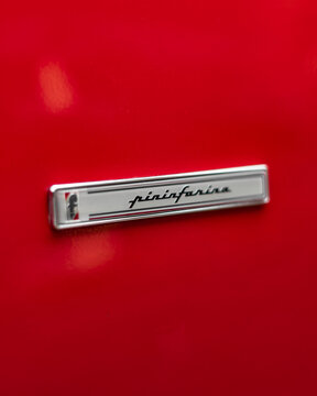 Red Ferrari Testarossa Pininfarina badge, Classic supercar side body with coachbuilder emblem