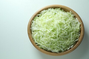 Fresh shredded cabbage on light table, top view. Space for text