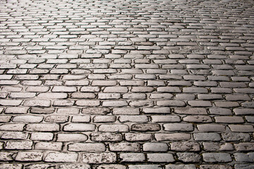 Cobblestone pavement background. Textured background of cobblestone road. Cobblestone pavement for background. Cobblestone road background.