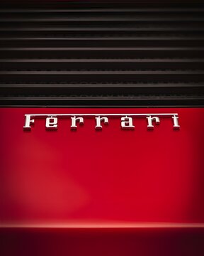 Red Ferrari Testarossa silver emblem detail, Classic supercar rear panel with chrome lettering badge