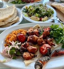 Traditional Turkish lamb kebab with onion, grilled meat with vegetables and salad