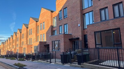 Row of Modern Townhouses with Black Windows and Fences
