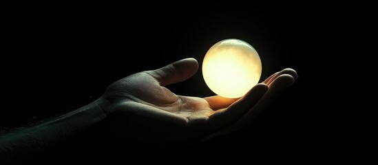 Glowing orb of light gently held in a person s hand symbolizing energy and inspiration