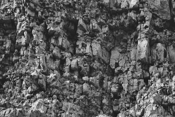 

Texture, background layers and cracks in sedimentary rock on cliff face. Limestone.