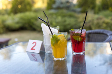 Two drinks on a table with a number 2 sign in front of them