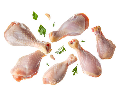 Flying raw chicken drumsticks cut out on isolated