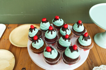 Blue velvet creamy cupcakes on a wooden shelf in a party