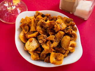 Hearty dish of fried skinny pieces sprinkled with salt and pepper