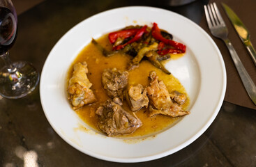 Appetizing fried chicken served with beer on plate with garnish