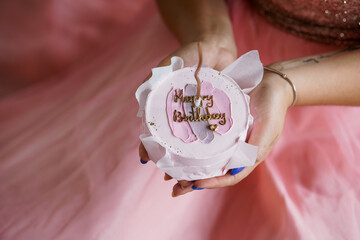 Elegant Birthday Celebration with a Beautiful Cake in a Soft Pink Setting