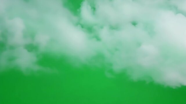 White Clouds Floating Against Green Screen Background
