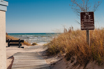 Board walk leading to Lake Michigan, with caution sign, within within Kohler-Andrae State Park, Sheboygan, Wisconsin
