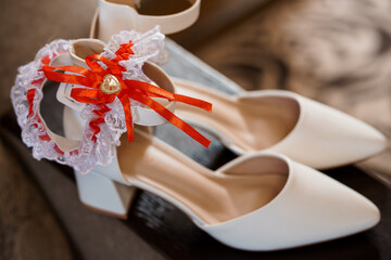 Elegant White Bridal Heels with Red Accents and Garter Decoration