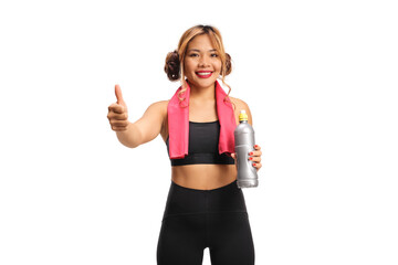 Filipina woman in sportswear holding a water bottle and gesturing thumbs up