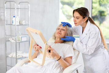 Doctor and patient in consultation before treatment or cosmetic surgery. Beauty industry concept.