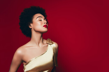 Photo of passionate stunning tender woman closed eyes wearing golden dress isolated on red background