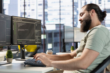 IT worker writing code, conducting experiments and tests to optimize machine learning models for...