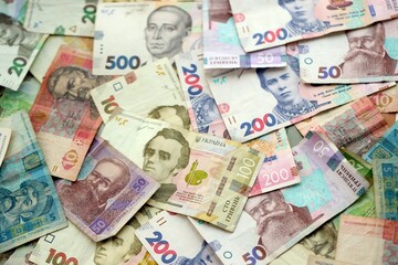 Big amount of different ukrainian hryvnia currency money bills in pile