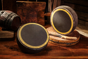 Traditional aged mountain cheese of the Alps offered as loafs in an alpine hut of a cheese dairy