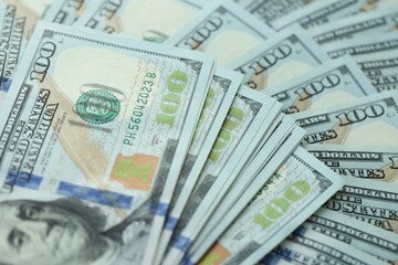 Many hundred dollar bills new banknotes in big pile under the natural light