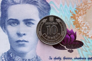 Ukrainian silver coin lies on two hundred hryvnia bill. Financial and business concept. Modern...