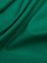Background - new green linen fabric. High-quality texture of expensive fabric.