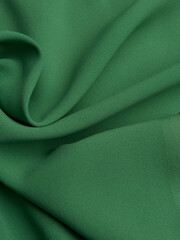 Background - new green fabric. High-quality texture of expensive fabric.